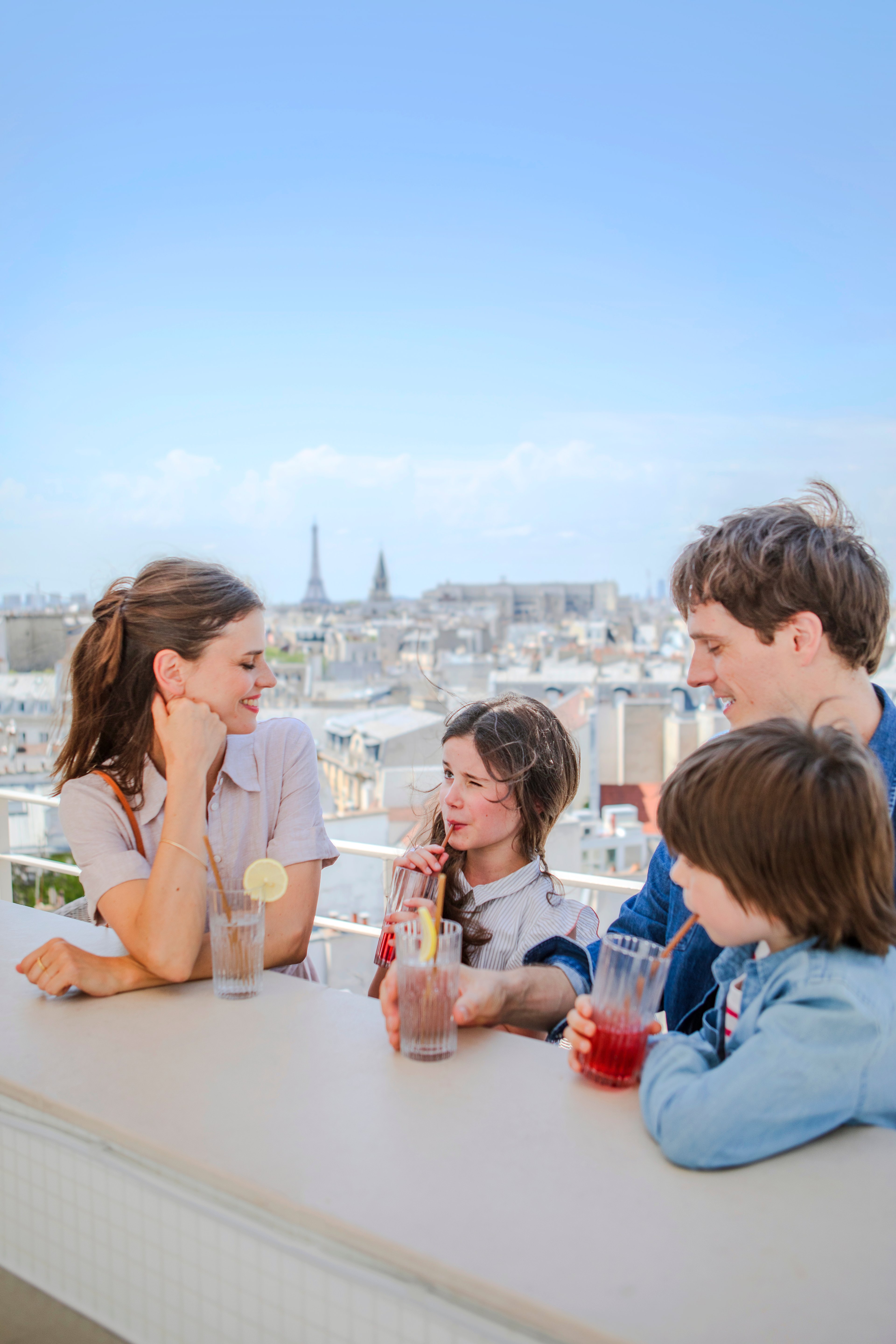 Family sharing drinks on a rooftop in Paris